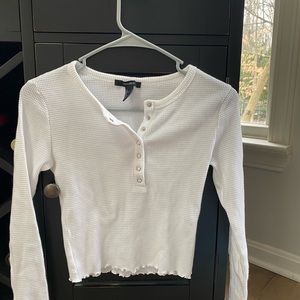 Forever 21 white ribbed button up shirt. Long sleeved. Detailed at the bottom.
